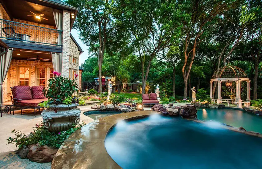 Luxury backyard with dark blue swimming pool and garden gazebo