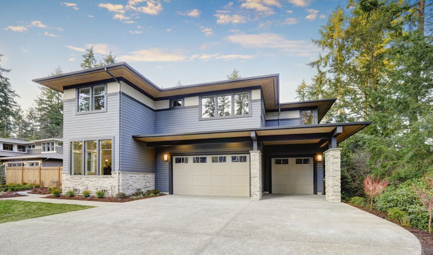 Contemporary home with white stone columns