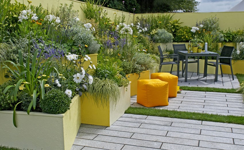 Garden patio with yello painted concrete planters
