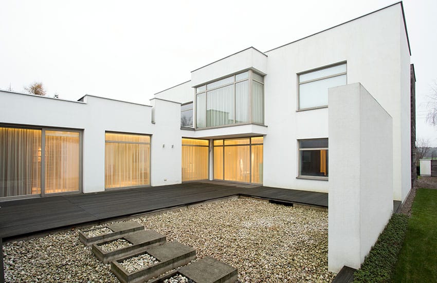 House with white walls and pea gravel ground cover