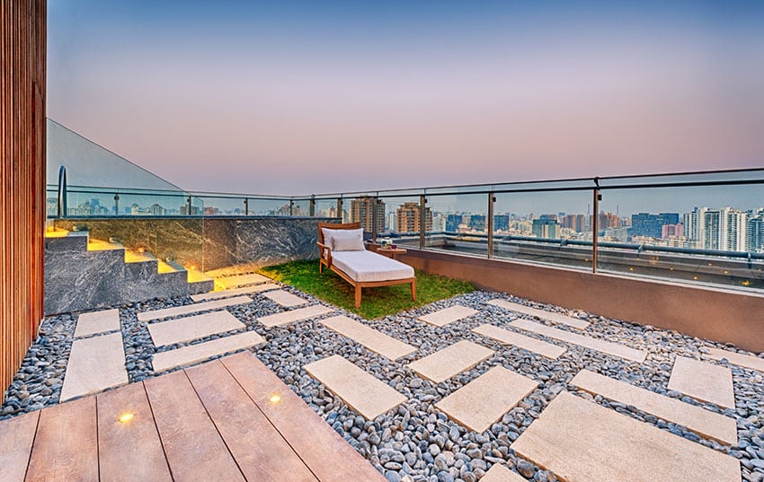 Modern rooftop patio with rocks and grass lounge area