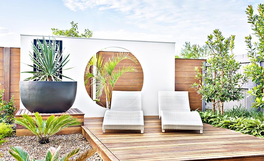 Modern wood deck with art wall and landscaping