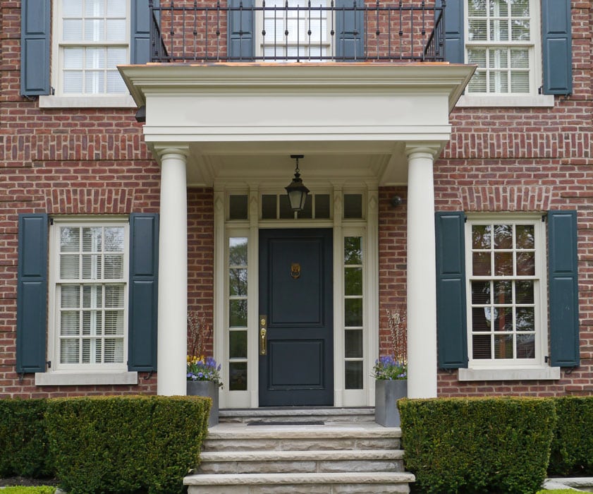 Red brick house dark blue door