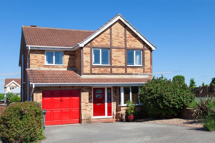 Red garage door color on brick house