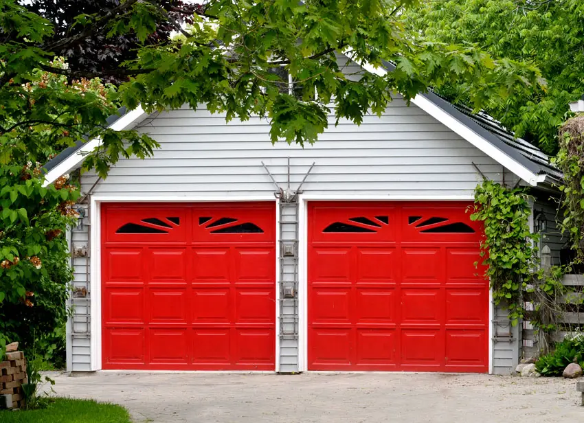 Red carport doors with decorative windows