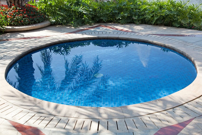 Small round dipping pool with concrete patio