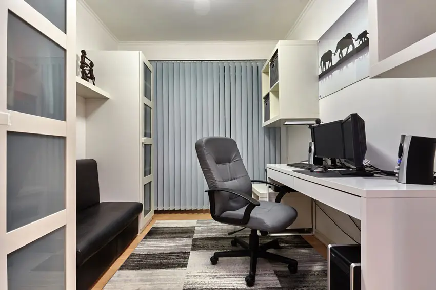 Small home office with white decor shelving and black bench