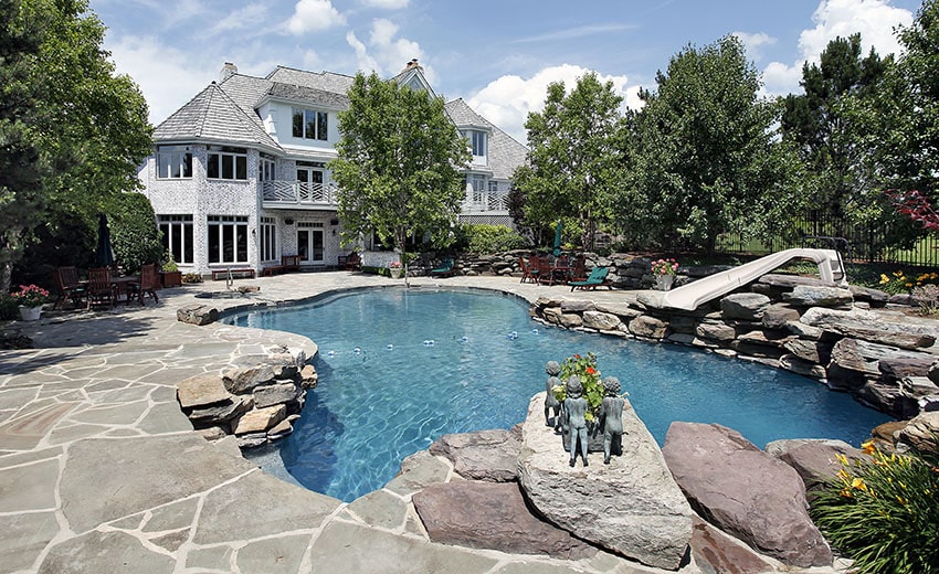 Swimming pool with flagstone patio and slide