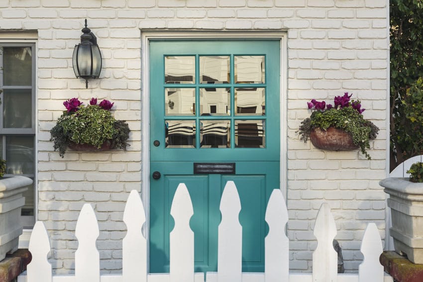 Teal front door on white house