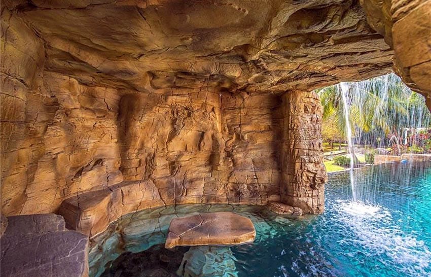Tropical lagoon swimming pool with waterfall cave