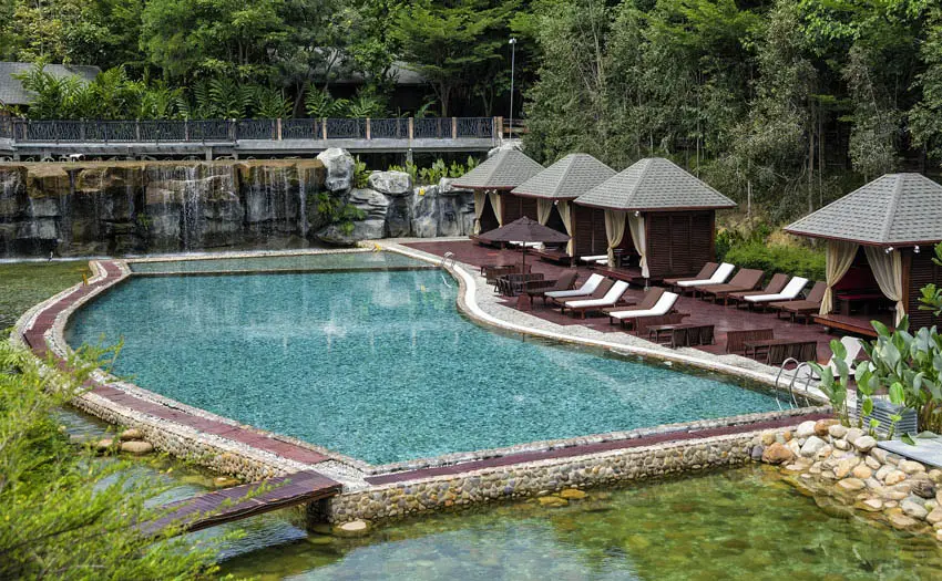 Tropical resort pool next to lagoon