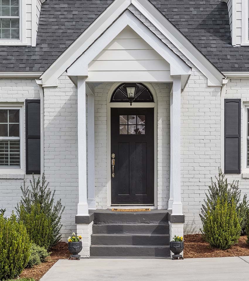 White brick house with gray front door, roof and shutters