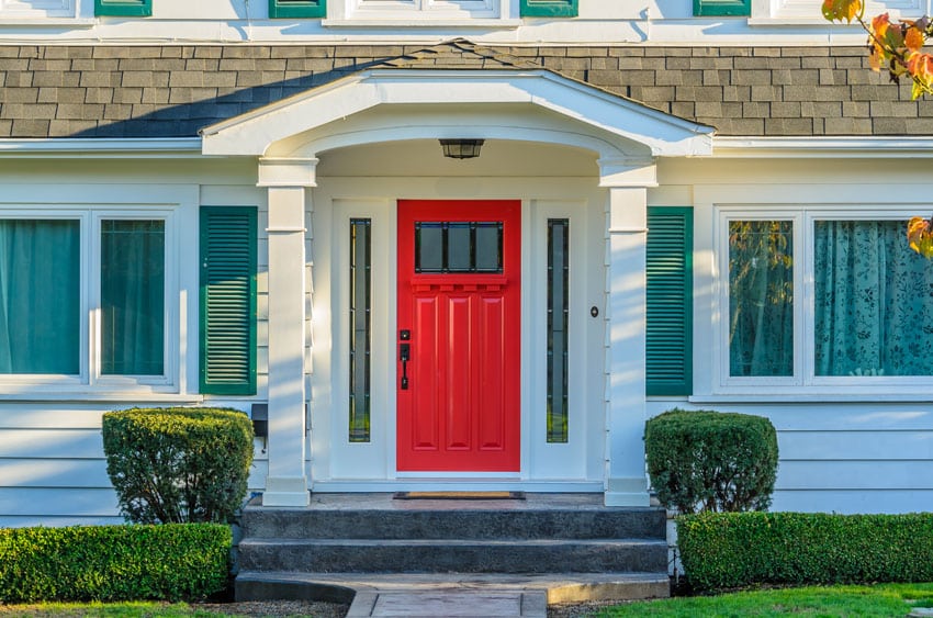 White porch with red colored door