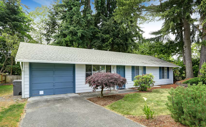 white house with blue garage door front door and window trim