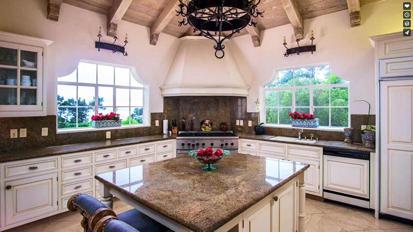 Antique white kitchen cabinets with brown granite island