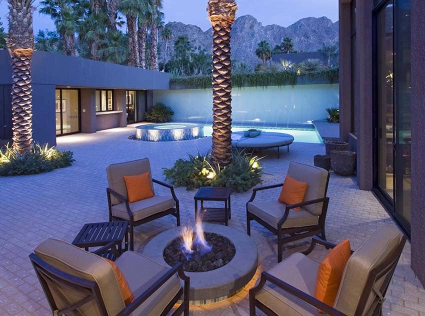 Beautiful backyard patio with firepit brick pavers and swimming pool