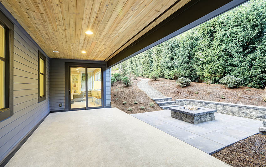 Concrete patio with firepit behind modern home