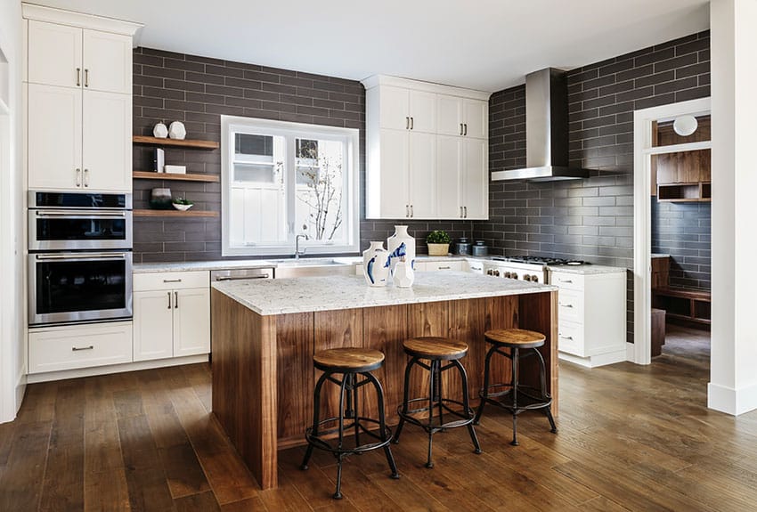 Island with brown cabinets against white cabinetry