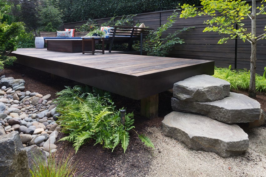 Elevated modern deck with large rock steps