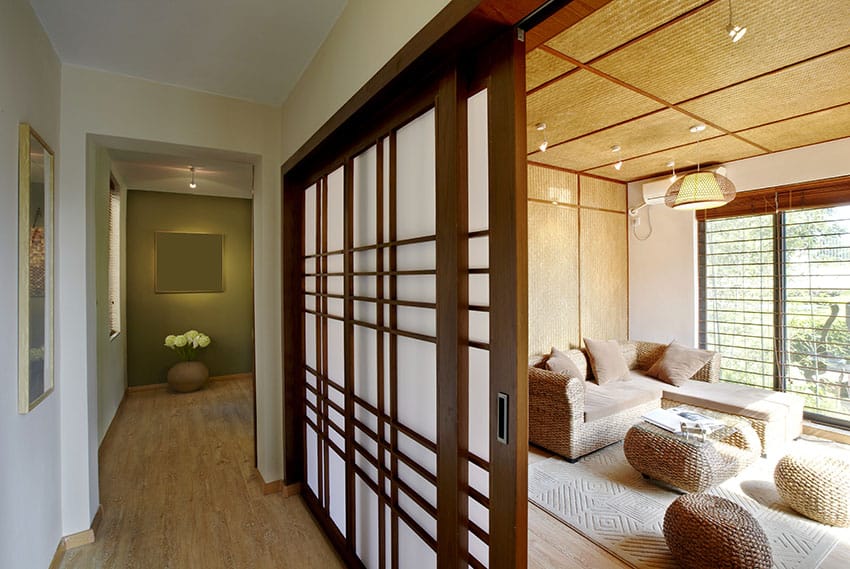 Japanese interior design with shoji sliding doors and rattan floor poufs and ottoman
