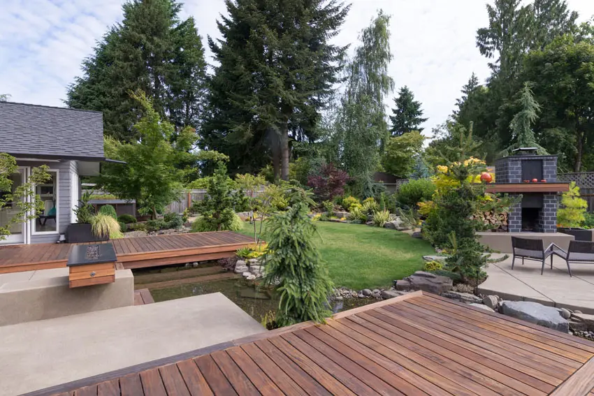 Modern deck around pond with gas fire pit