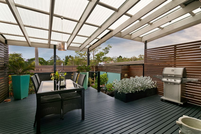 Dark stained deck with canopy and privacy wall