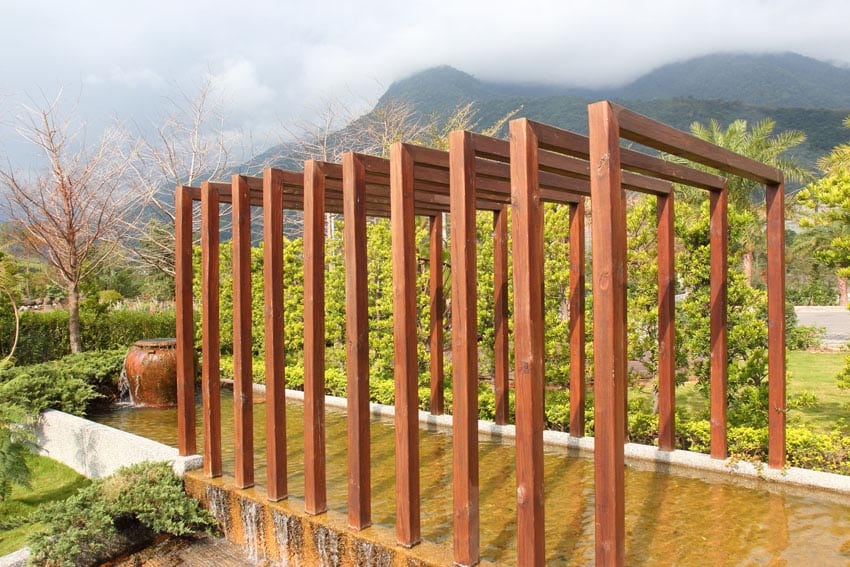 Modern pergola above water feature pond with mountain views