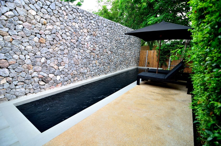 Pool and private villa with rock privacy wall
