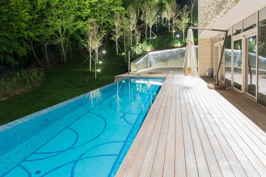 Pool with decorative bottom design and wood flooring