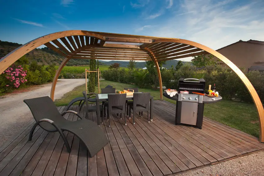 Modern wood pergola with arched frame above deck