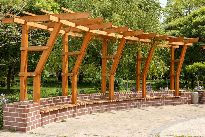 Modern wood pergola with brick bench