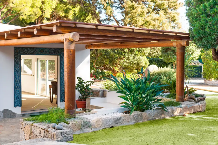 Wood pergola with large log beams and canopy