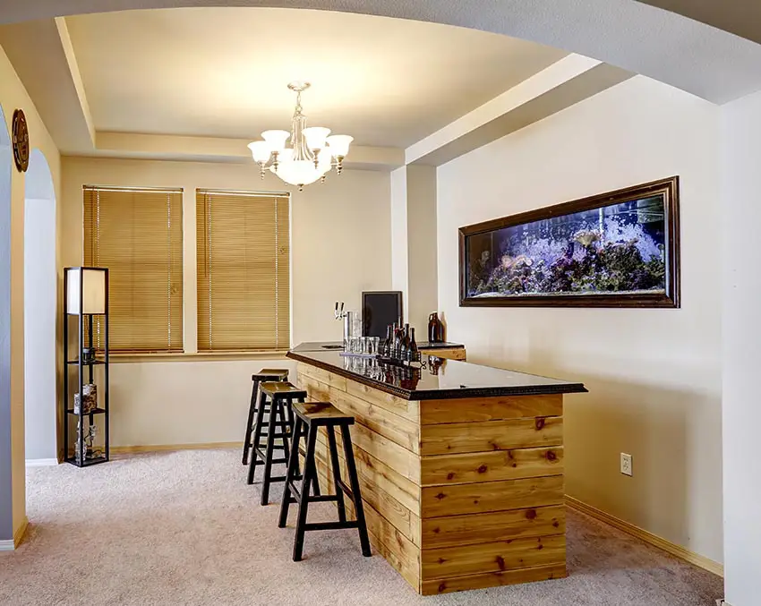 Bar with wood countertop and aquarium accent wall