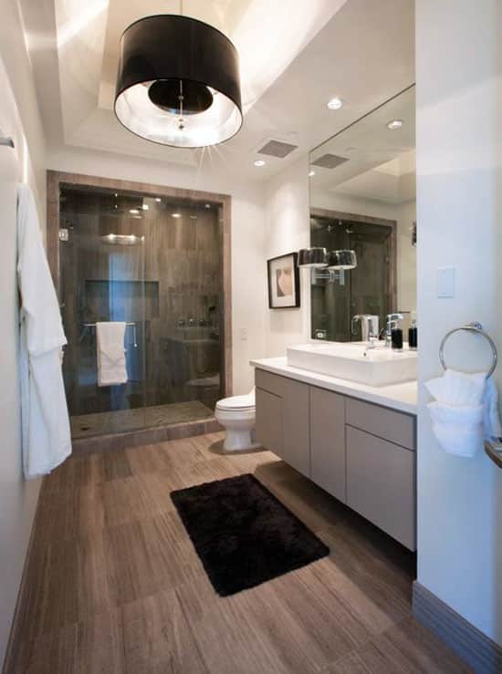 Bathroom with wood style laminate flooring and drum pendant light