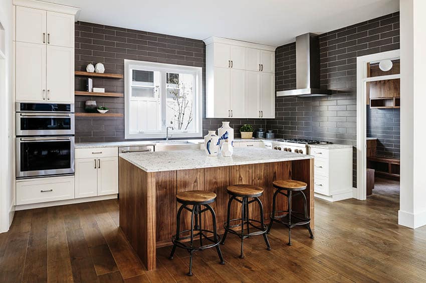 kitchen with brown island with marble solid slabs, and wood board floors