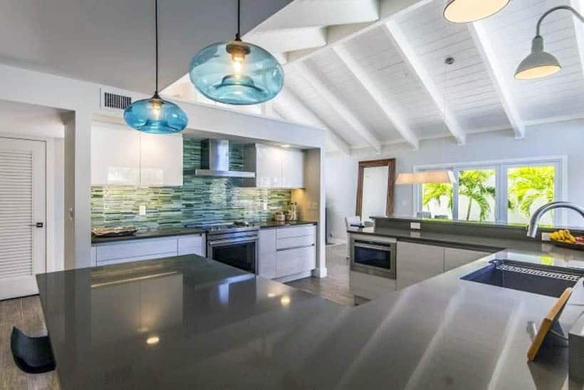 kitchen with white gloss cabinets gray peninsula and aqua glass mosaic tile backsplash