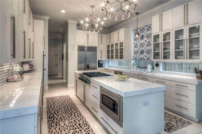 kitchen with white glass door cabinets calacatta carrara marble counters and marble flooring