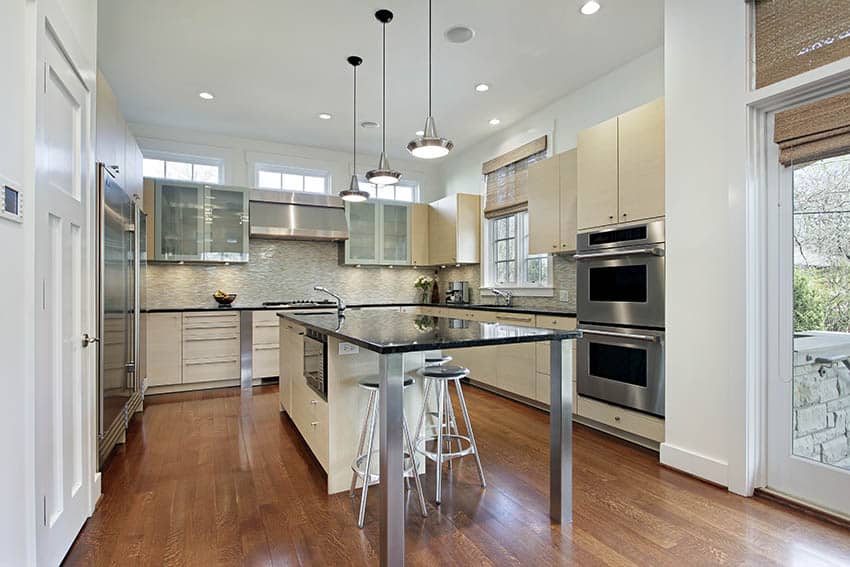 contemporary u shaped kitchen with cream color cabinets and black granite island