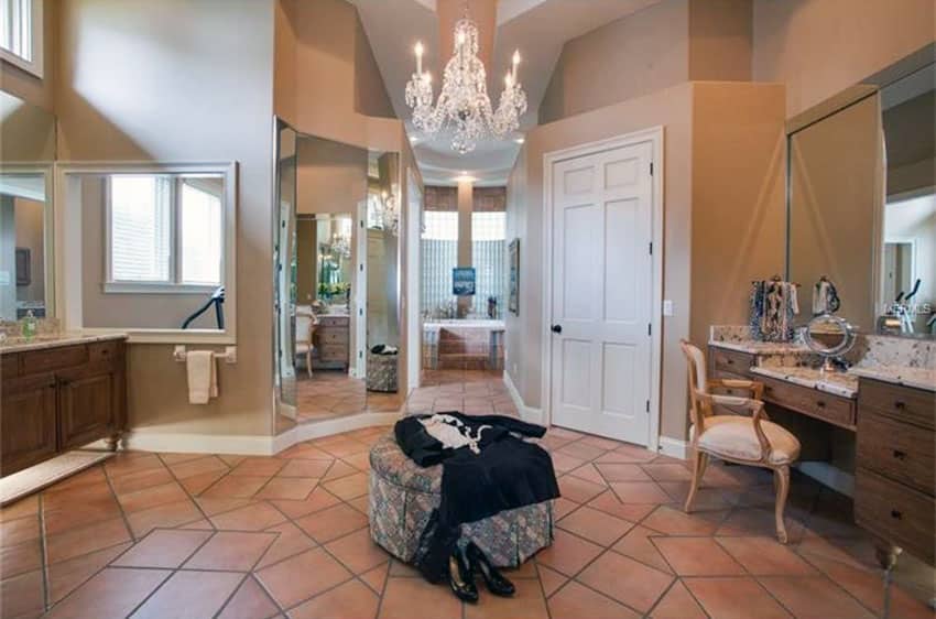 Master bathroom with terra cotta floor tiles and chandelier