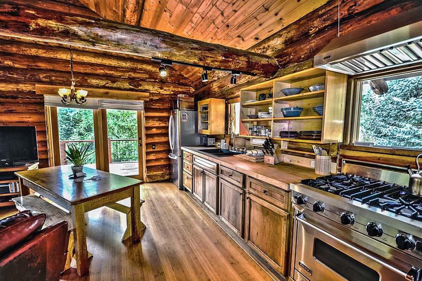 Single wall log knotted cabin kitchen with wood countertops
