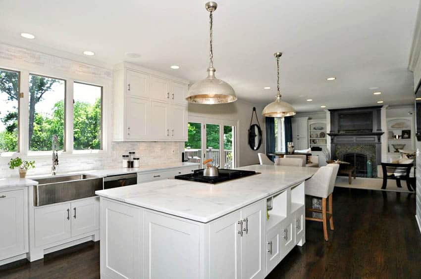 Traditional kitchen with white shaker cabinets carrara marble backsplash countertops