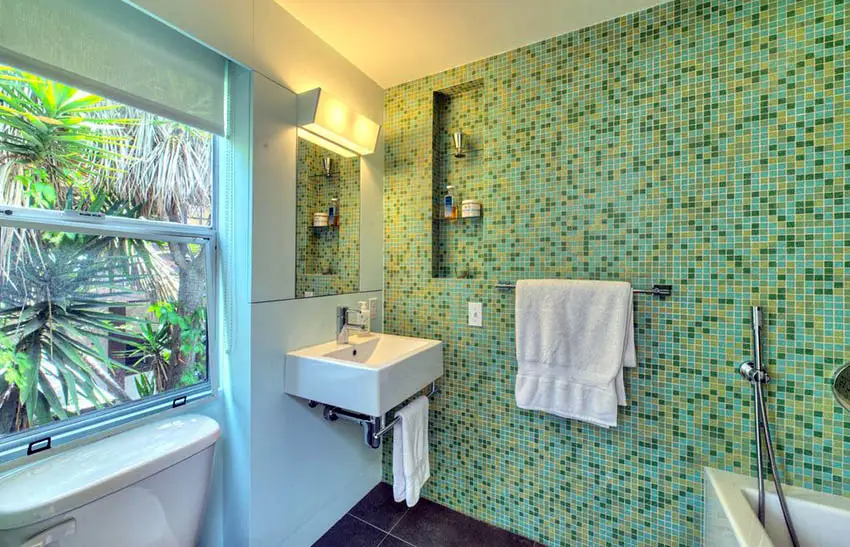 Bathroom with green mosaic tile wall and awning window