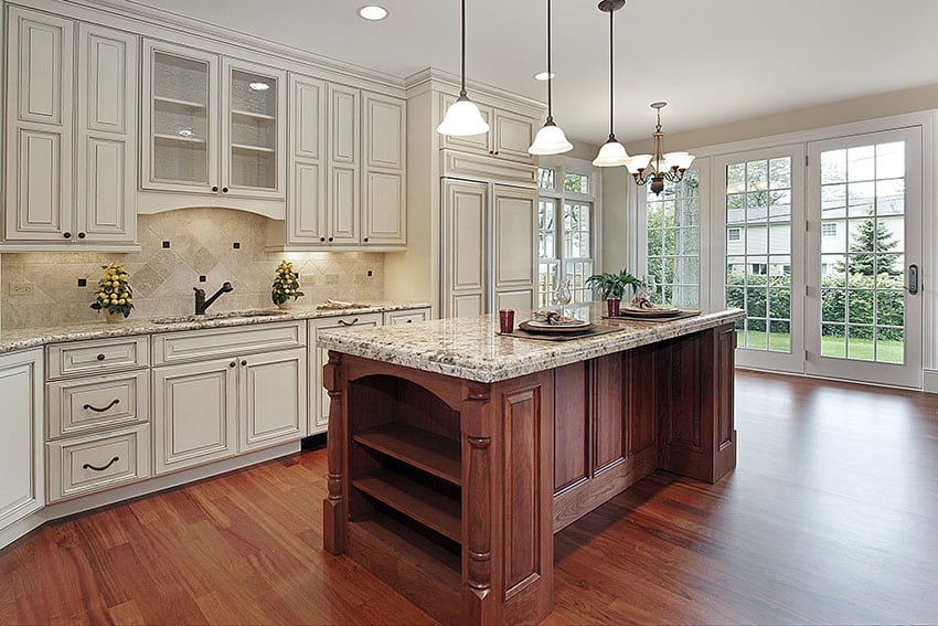Beautiful country kitchen with off white raised panel cabinet doors and brown stained island