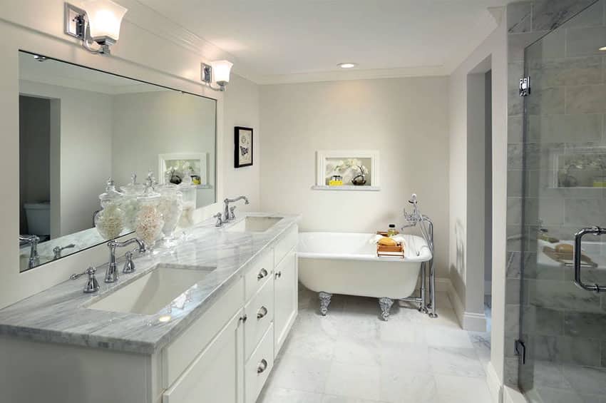 Bathroom with clawfoot tub and marble flooring