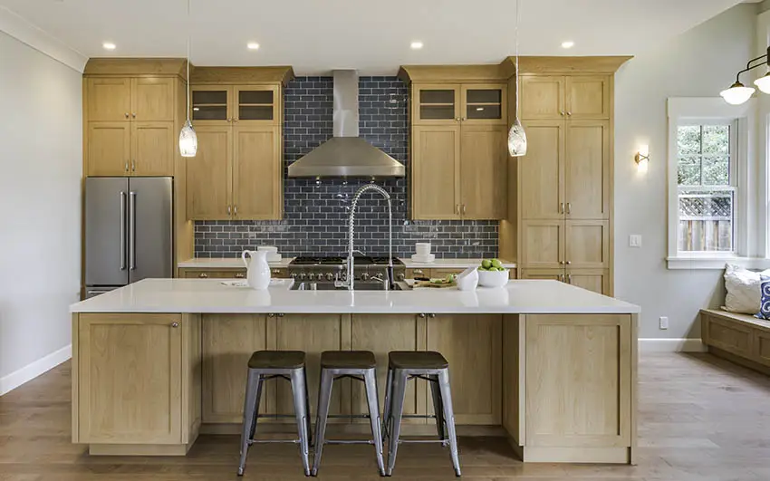 Kitchen with gray subway tiles, arched doorway and sconces