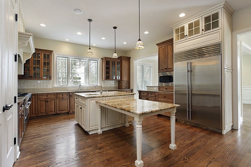 Country style kitchen with white and brown cabinets wood floors and granite countertops