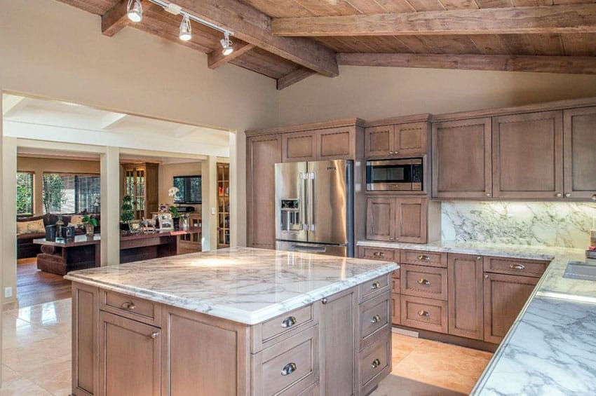 Craftsman created kitchen with flat door style cabinets, marble countertops and vaulted ceiling