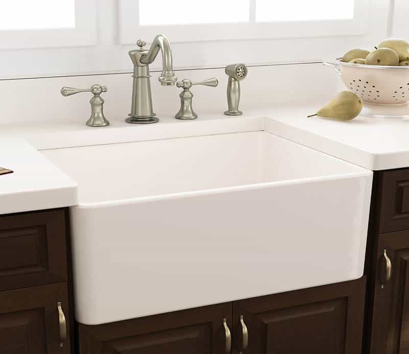 FWhite apron style sink with wood cabinetry