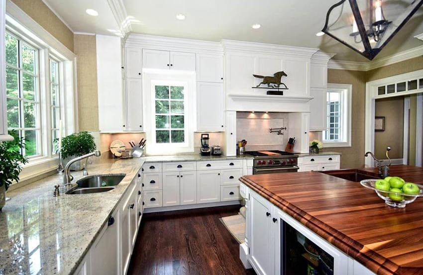 Farmhouse kitchen with white flat panel cabinets and wood counter island