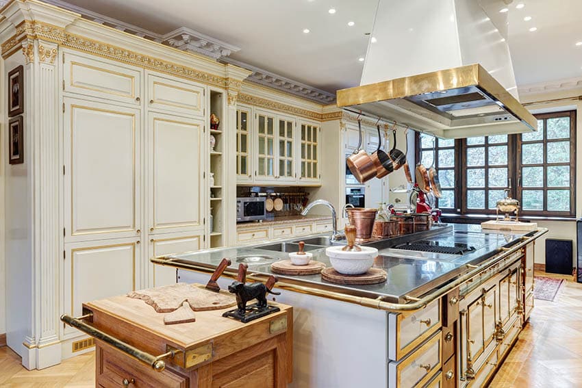 Kitchen with two toned cream mullion cabinets with gold trim